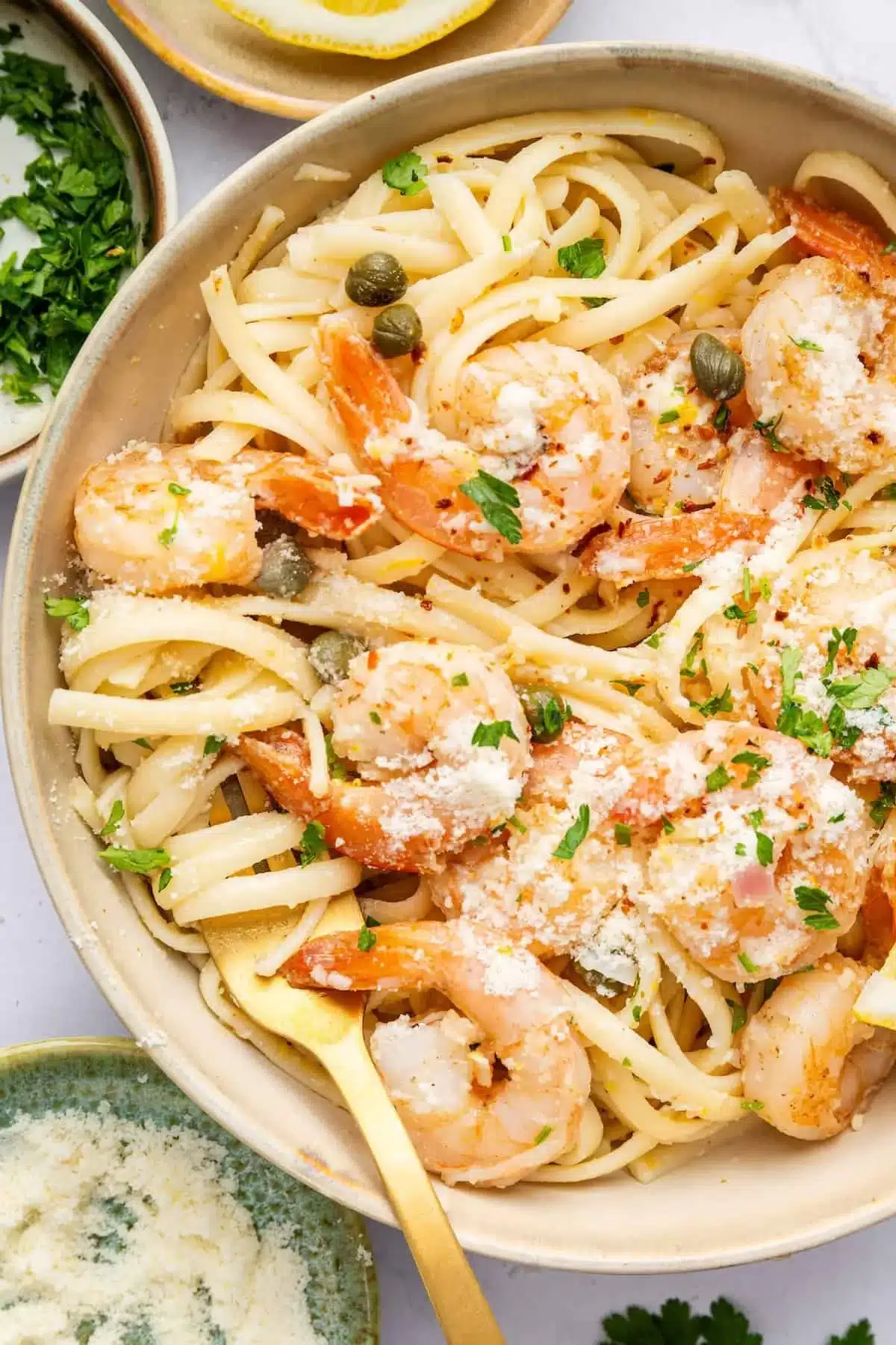Easy Shrimp Scampi Recipe 2 Easy shrimp scampi served over pasta garnished with herbs and lemon slices