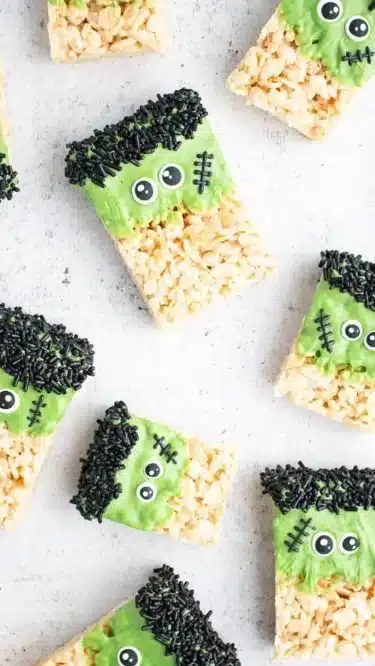 Frankenstein Halloween Rice Krispie Treats decorated with green frosting and candy eyes