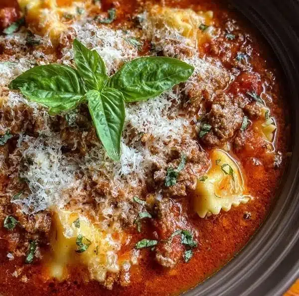 Crock Pot Lasagna Soup served in a bowl with cheese and herbs