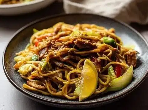Bowl of delicious Vegan Canton Noodles garnished with fresh vegetables