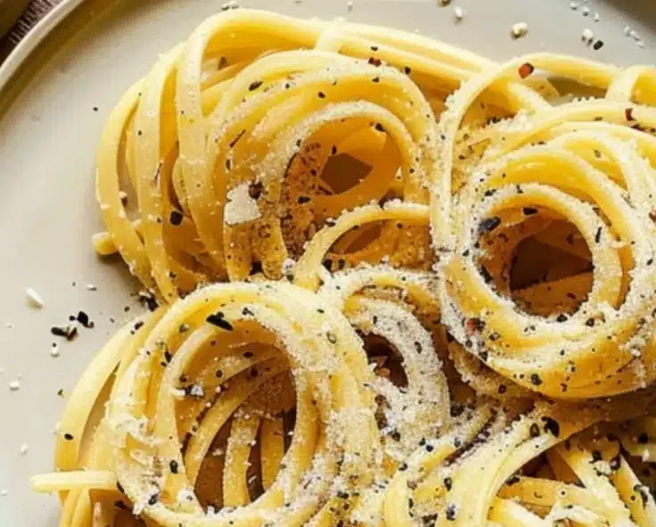 Delicious Black Pepper Parmesan Pasta Twirls served on a plate with fresh herbs