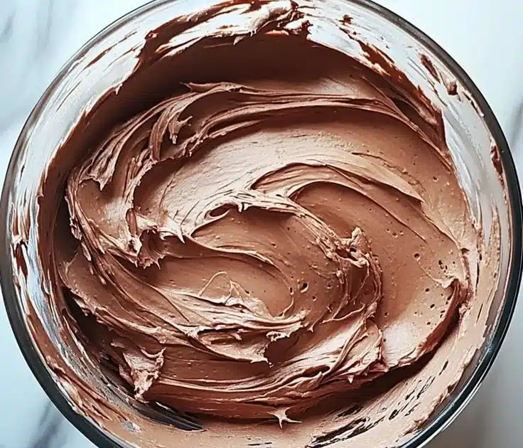 Decadent chocolate buttercream frosting in a bowl ready for decorating