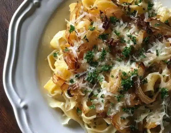 French onion soup pasta topped with melted Gruyère cheese in a bowl.