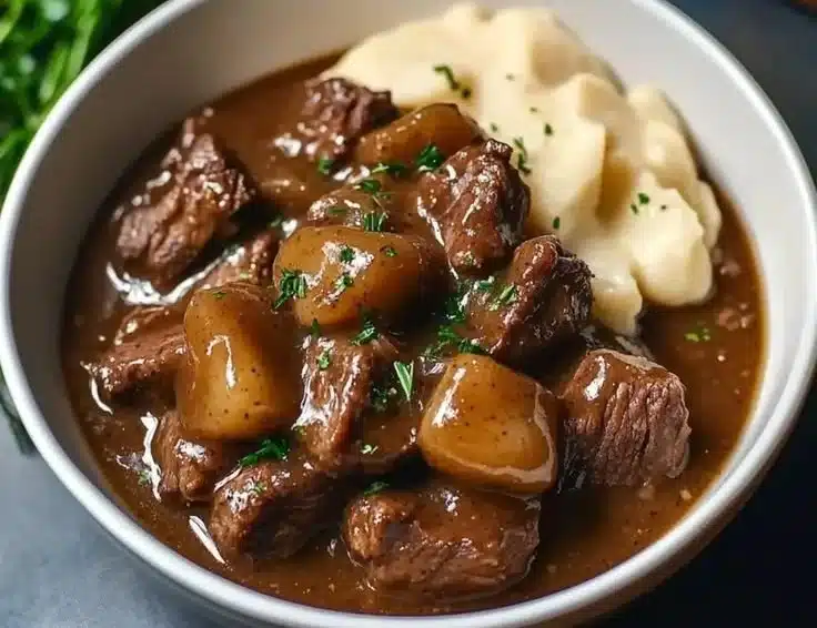 Delicious crock pot beef tips simmering in rich gravy