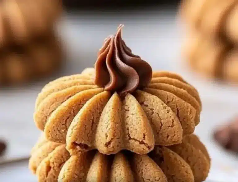 Plate of homemade Peanut Butter Blossoms cookies topped with chocolate kisses.