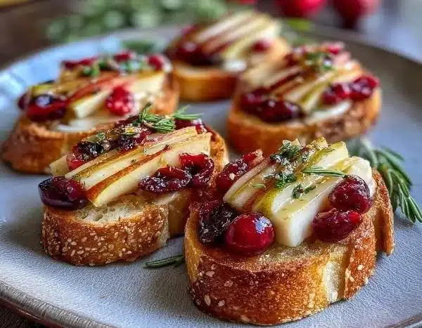 Delicious Pear Brie Cranberry Crostini served on a platter