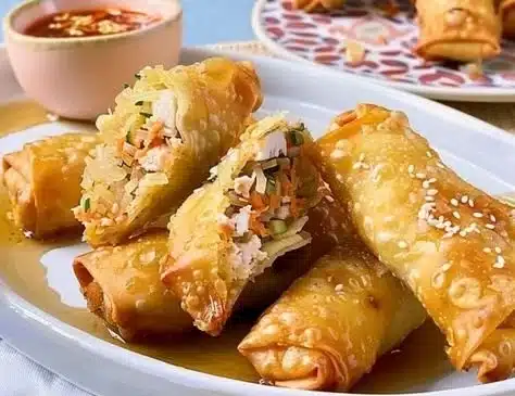 Pork and sauerkraut spring rolls on a serving platter